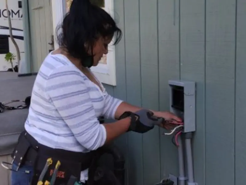 Licensed electrician wiring an exterior subpanel in Red Bay