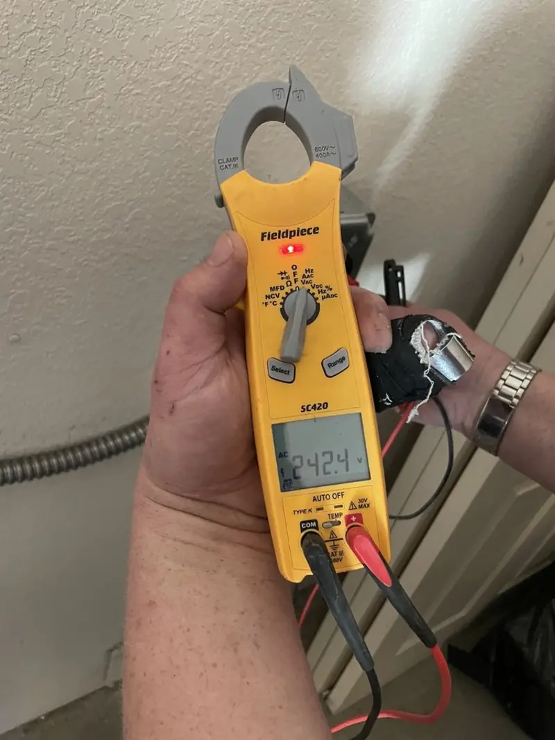 Voltage testing with clamp meter during Recessed Lighting Installation in Red Bay